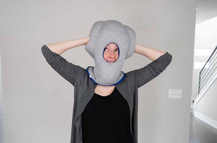 woman wearing the Ostrichpillow Original Travel Pillow