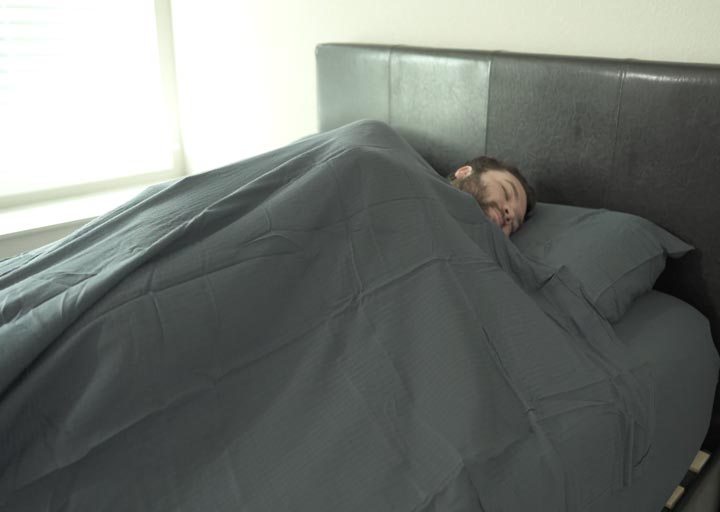 man asleep under Casper Hyperlite sheets