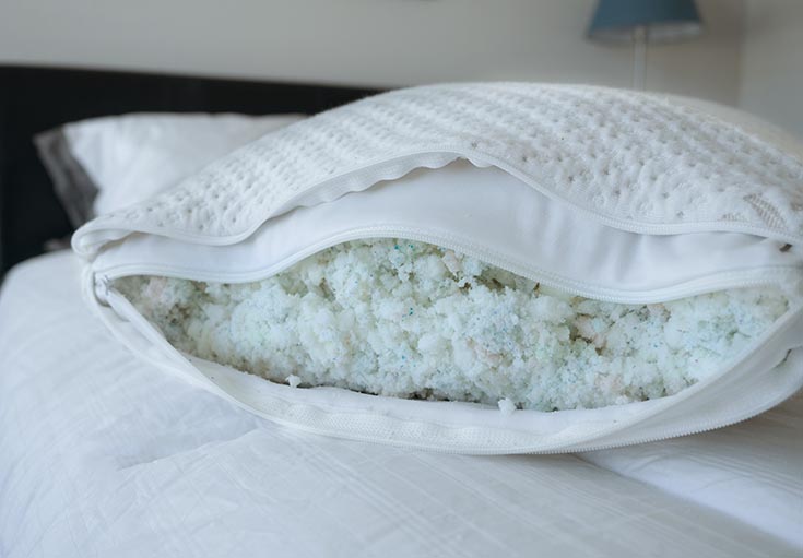 A pillow is opened to show its fill. A pillow is opened to show its fill.