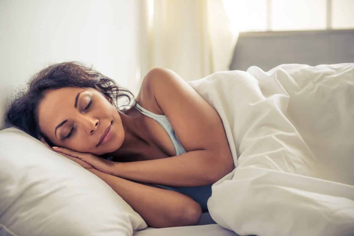 woman sleeping on side in bed