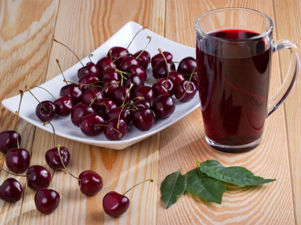 A grouping of fruit on a wooden table.