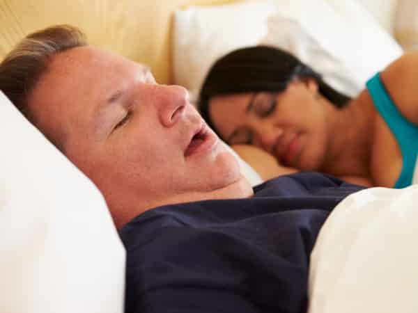 A man rests next to a woman.