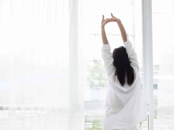 A woman stretches in the morning.