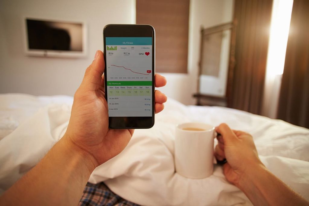 An image of a hand holding a phone with sleep tracking information on it