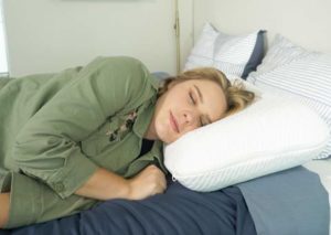 Tuft & Needle foam pillow side sleeping The Best Firm Pillows - A woman sleeps on her side with the Tuft & Needle foam pillow