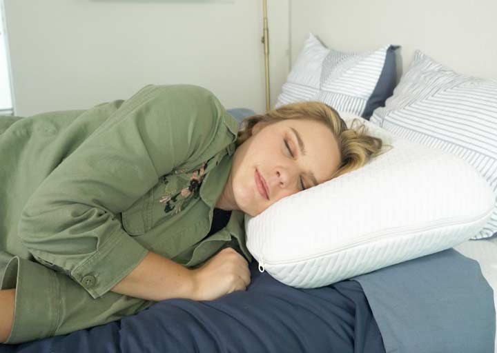 A woman sleeps on her side using the Tuft & Needle Original Foam pillow. A woman sleeps on her side using the Tuft & Needle Original Foam pillow.