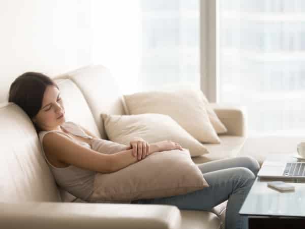 A woman rests on the couch.