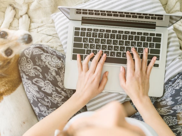 A woman types on her computer.