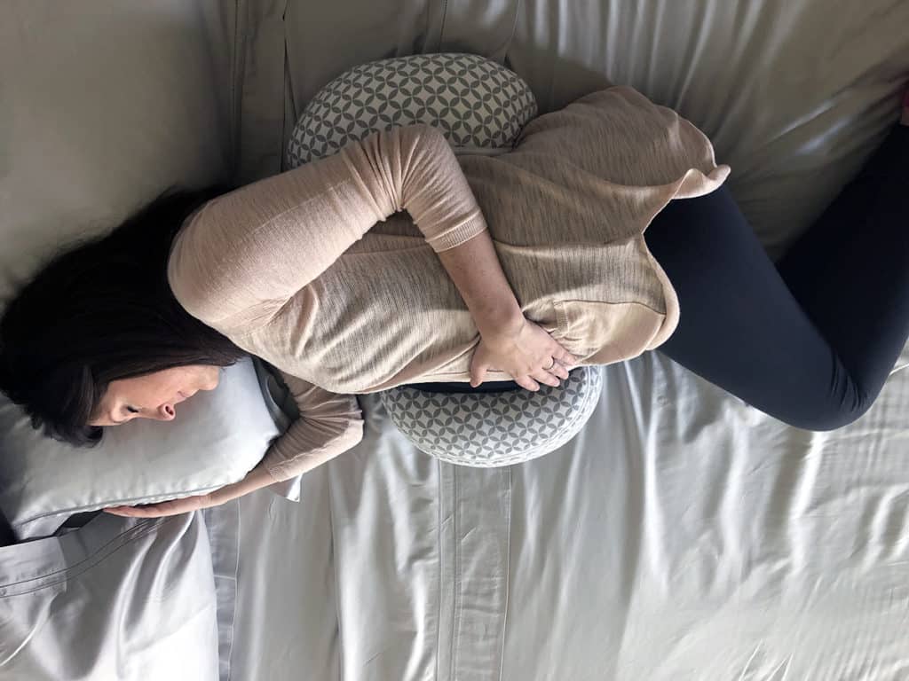 Pregnant woman testing a mattress