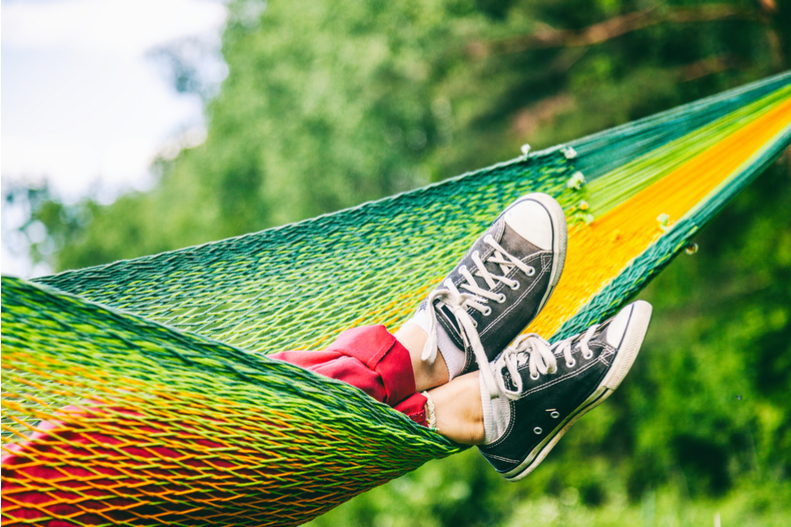 I woman rests in a hammock.