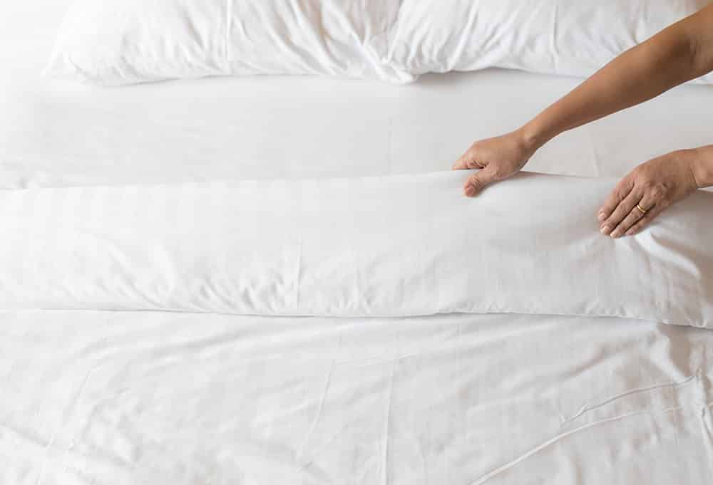 white sheets with a single hand