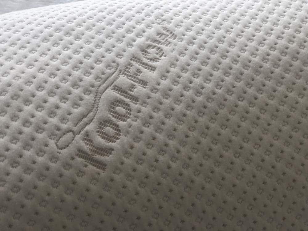 A close up of the Snuggle-Pedic cover that reads "kool-flow"