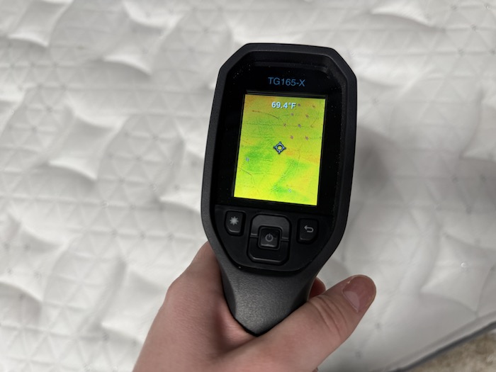 Taking a temperature reading before lying on the Helix Plus