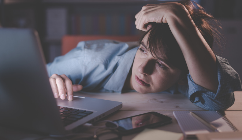sleep deprived woman at work