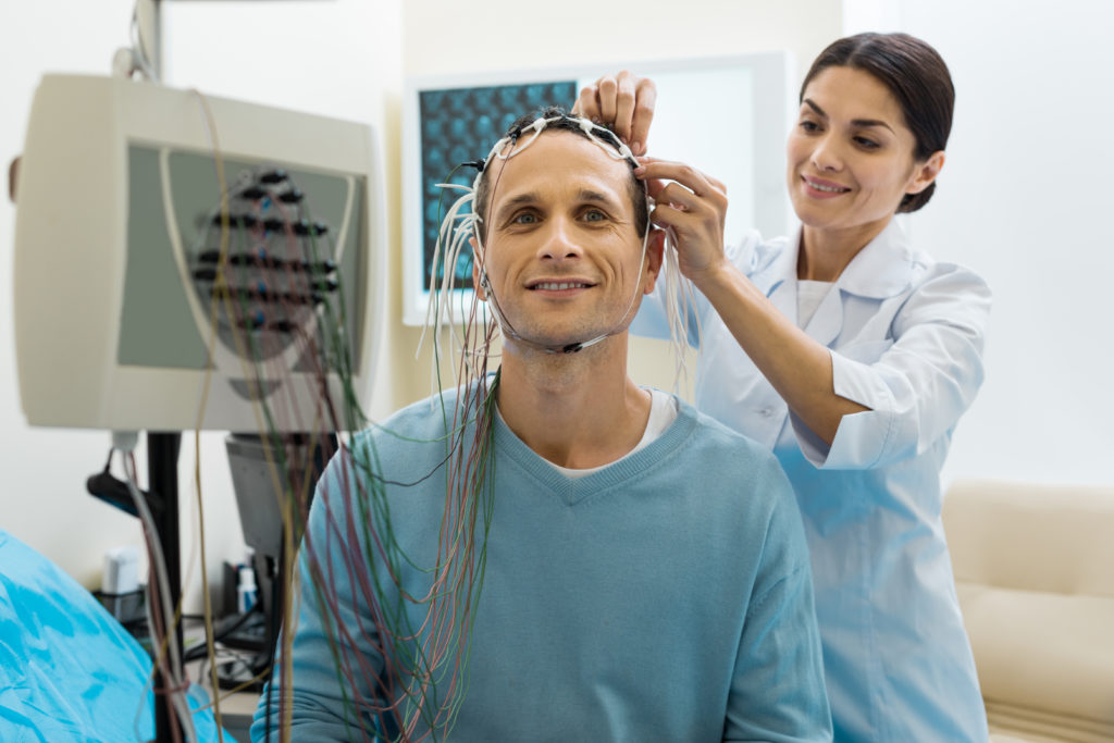 Doctor applying electrodes to research patient