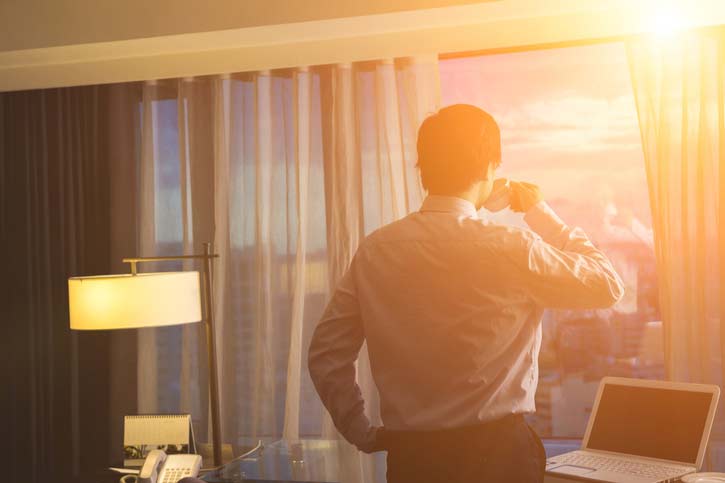 A Businessman Watches The Sunrise