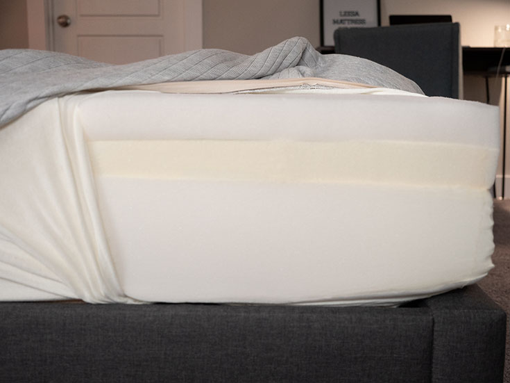 A mattress is opened to show its construction.
