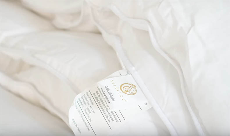 A close up of a white comforter