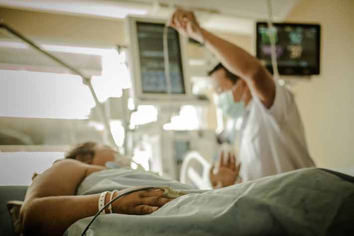 A doctor checks a patient's vitals. 