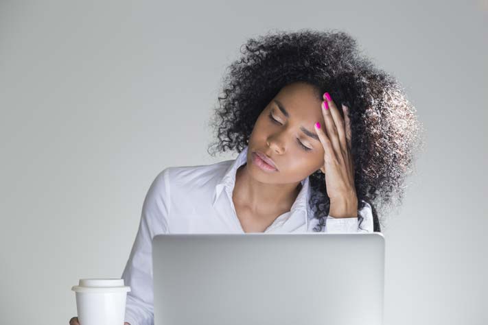 a woman is stressed at work