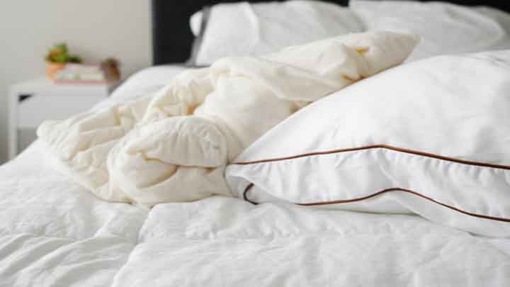 A Saatva Pillow sits on a bed 