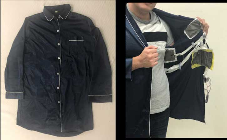 A researcher shows the sensor patches in a pajama shirt.