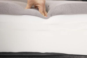 a person presses into a mattress's comfort layer