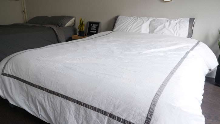 A high shot of a bed with a white duvet.
