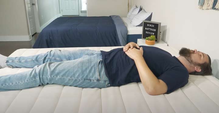 man laying on his back on the Birch Natural mattress