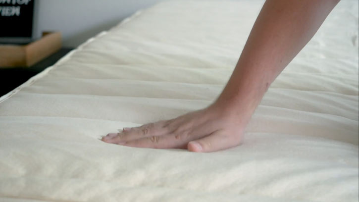 Hand Resting On The Birch Plush Pillow Top