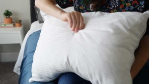 woman holding clean pillow