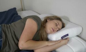 Purple pillow side sleeping The Best Firm Pillows - A woman sleeps on her side with the Purple pillow.