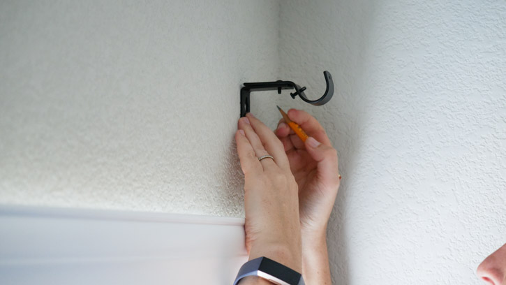 Use your mounting bracket and pencil to mark the spot where you'll drill a hole for the screw