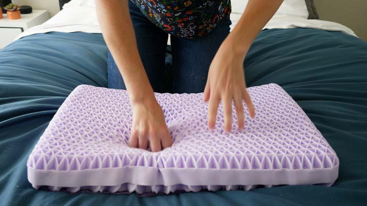 Hands press on the Purple Pillow flex grid.