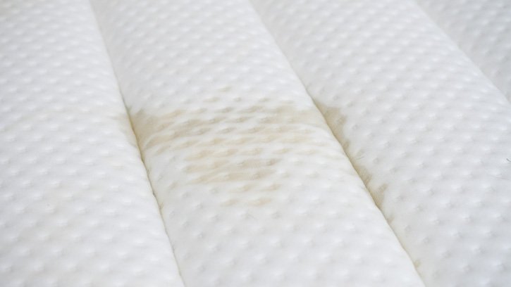 A stain sits on a pillow top mattress