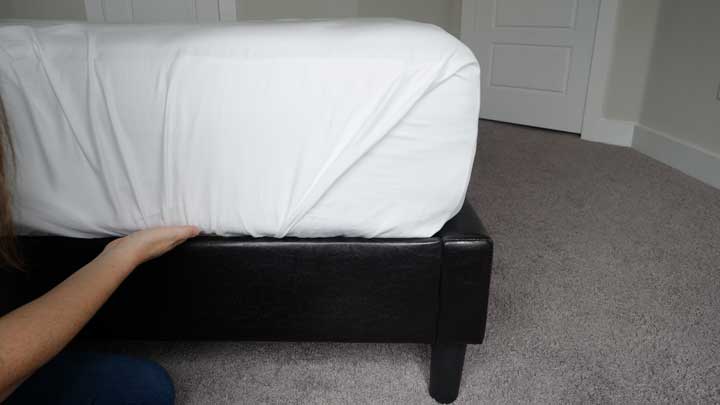 tuck the final piece of flat sheet into your mattress to create a hospital corner