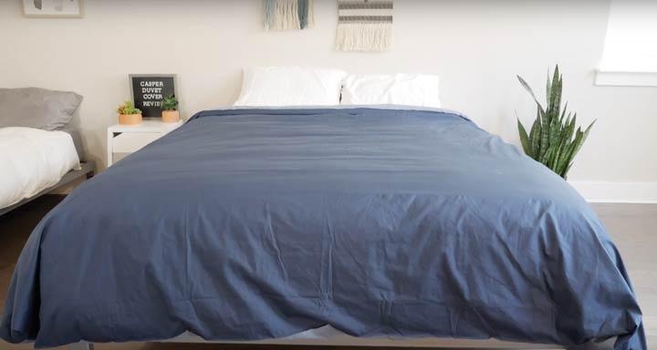 A wide shot of a bed with minimalist design