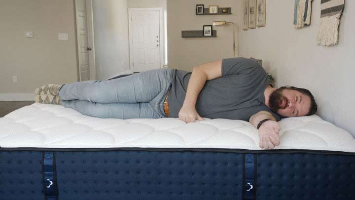 man laying on side on DreamCloud mattress