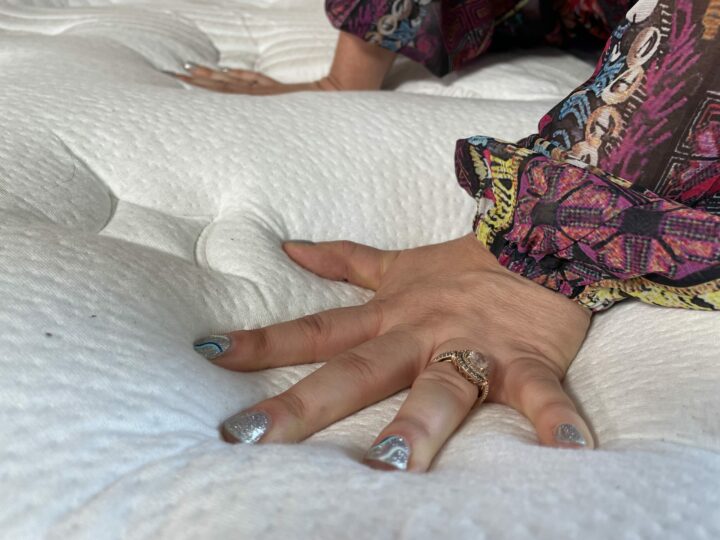 a woman presses into the Nolah Evolution mattress