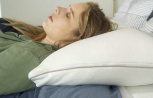 Sleep Number True Temp Pillow Back Sleeping A woman sleeps on her back with the Sleep Number True Temp pillow