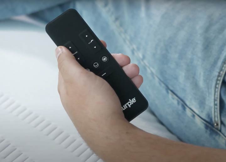A hand holds the Purple Ascent remote.