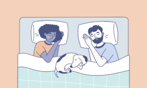 couple sleeping in bed with dog