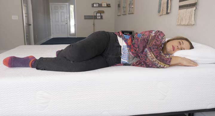 woman sleeping on her side on the Puffy Lux mattress