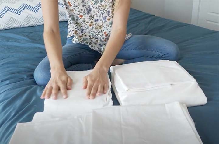 A woman brushes her hands over the Sleep Number True Temp Sheets