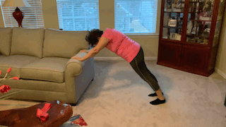 Woman doing pushups on couch
