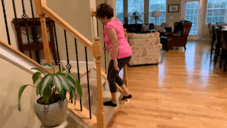 Woman doing step ups on staircase