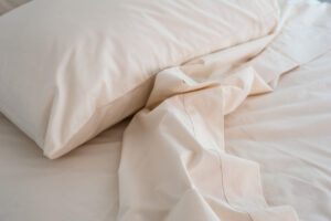 American Blossom Linens sheets - a picture of a sheet and a pillow on a bed