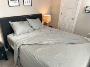 An image of a bed with the slate colored Helix Ultra-Soft Tencel sheet set on it.