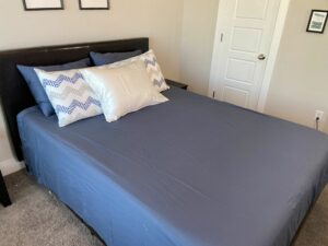 A bed made with decorative pillows