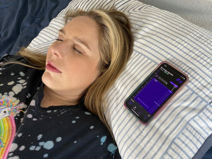 A woman rests next to the RISE app